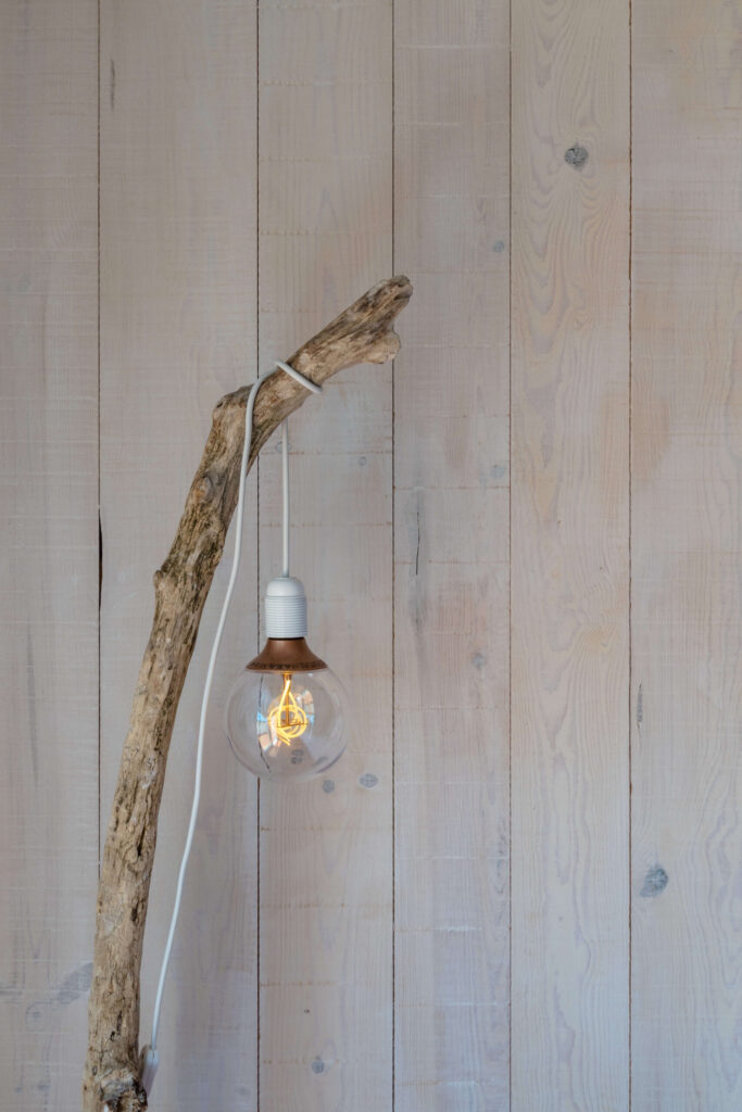 a wooden lamp made from recycled rural materials