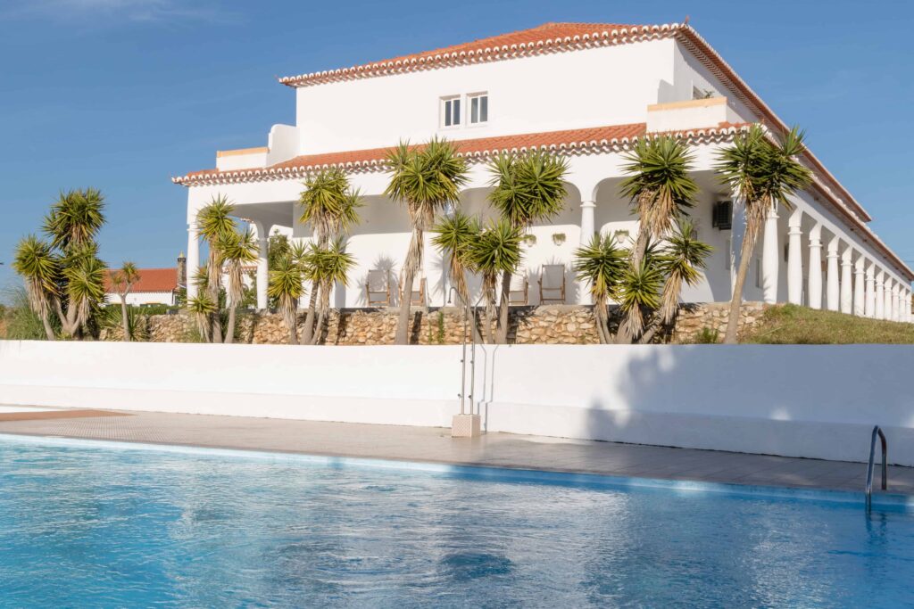 The large pool outside of utopia guest house with outdoor and indoor showers